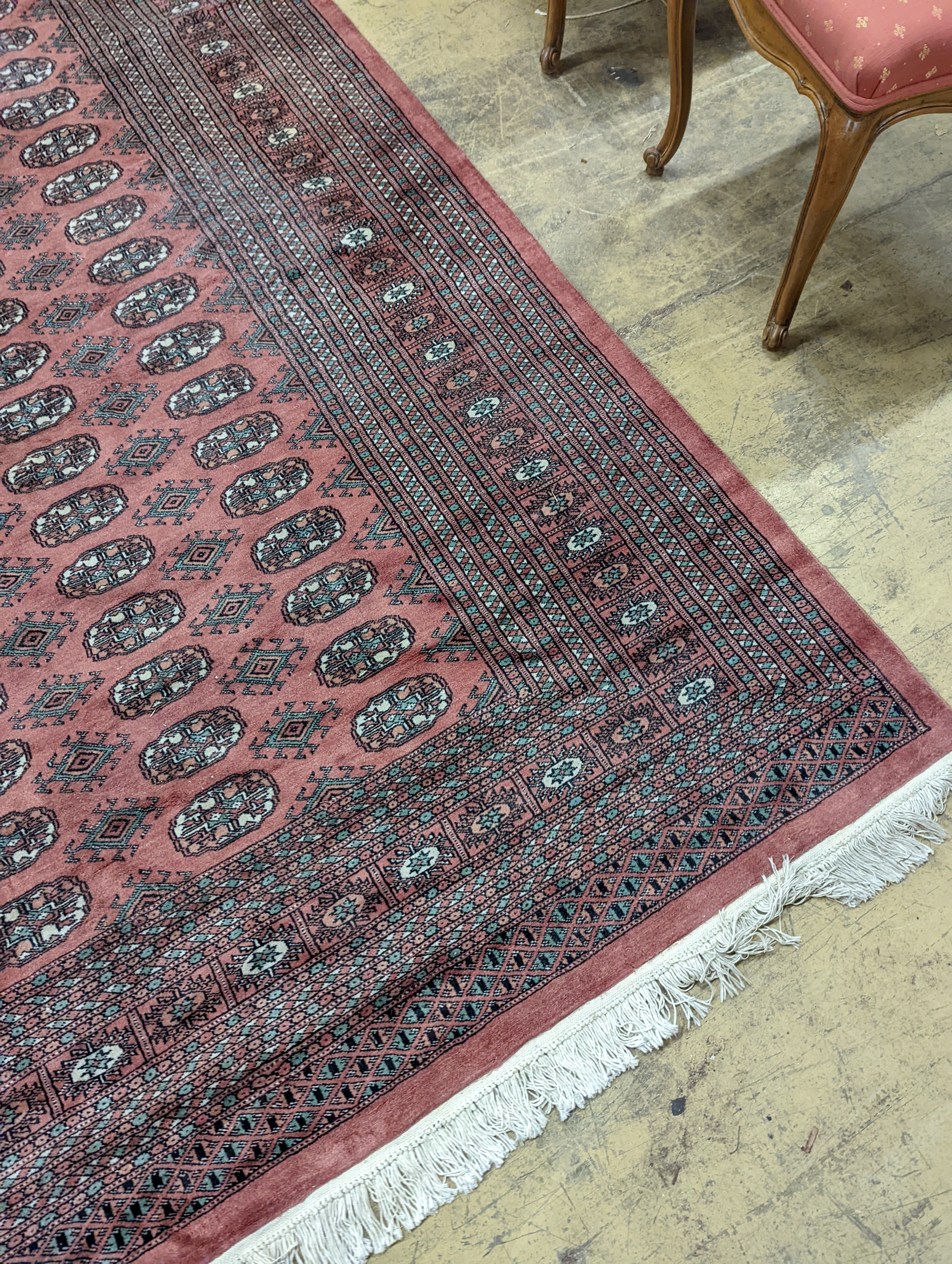 A pink ground Bokhara carpet, 315 x 220cm